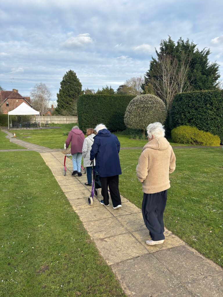Residents walking on a pathway in a garden