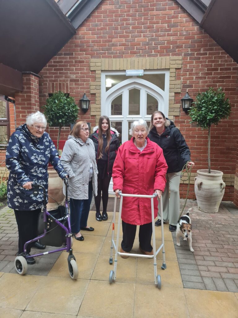 Residents and staff outdoors at the facility