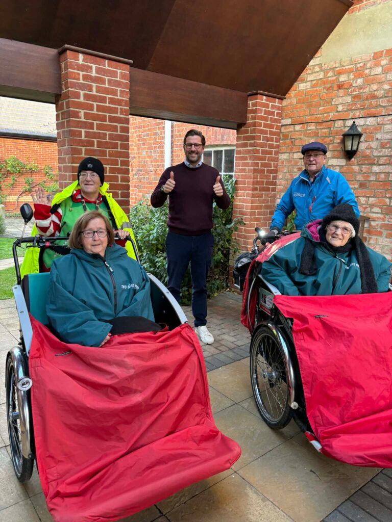 Residents enjoying outdoor time in wheelchairs.