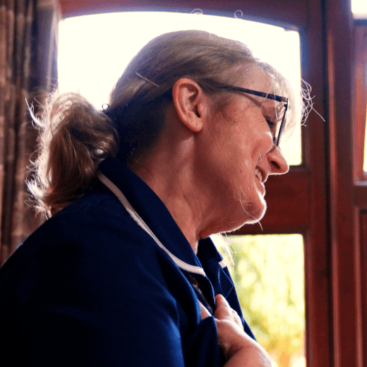 Staff member interacting warmly by a window