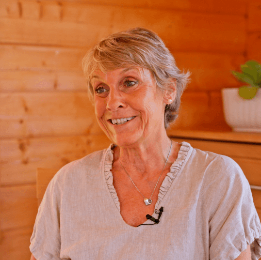 Smiling senior woman in a cozy indoor setting.