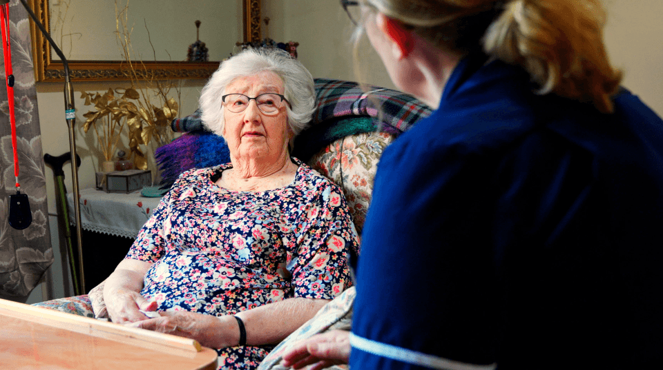 Elderly resident interacting with staff member