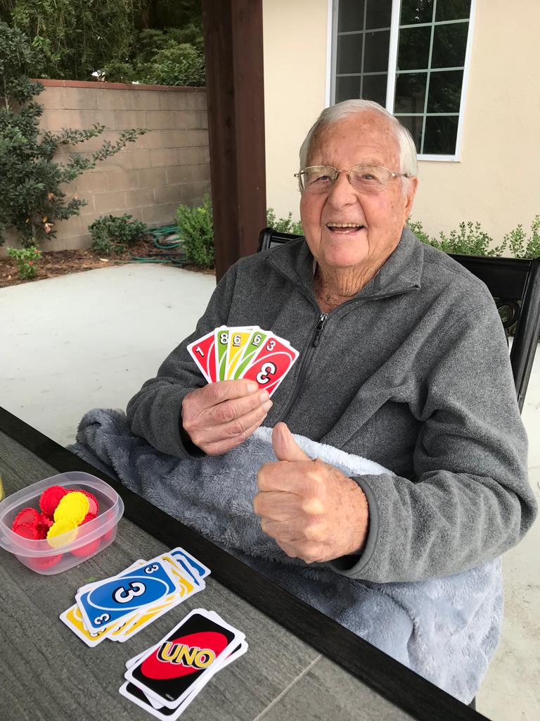 Resident enjoying a game of UNO outdoors