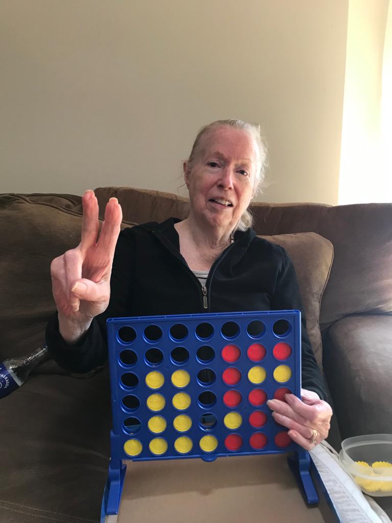 A resident enjoying a game of Connect Four.