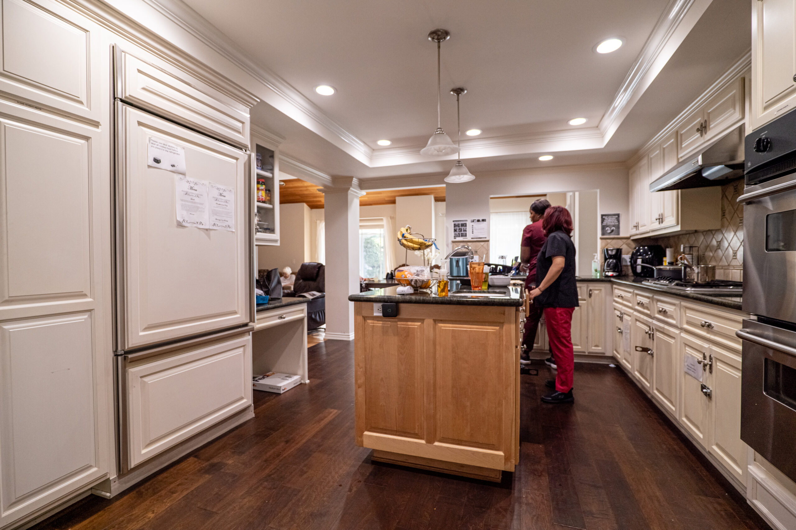Residents interacting in a kitchen setting