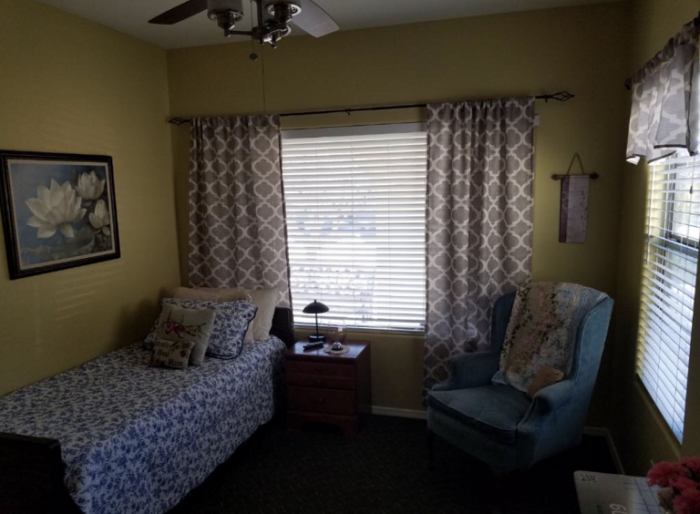 Cozy private resident room with a bed and chair