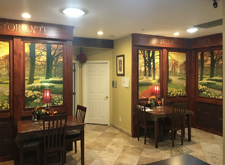 Interior dining area with tables and decorative paintings
