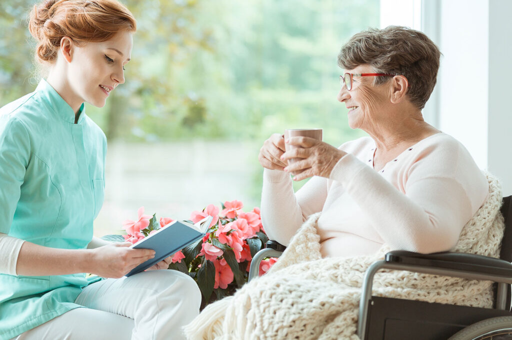 Staff member assisting a resident with a book