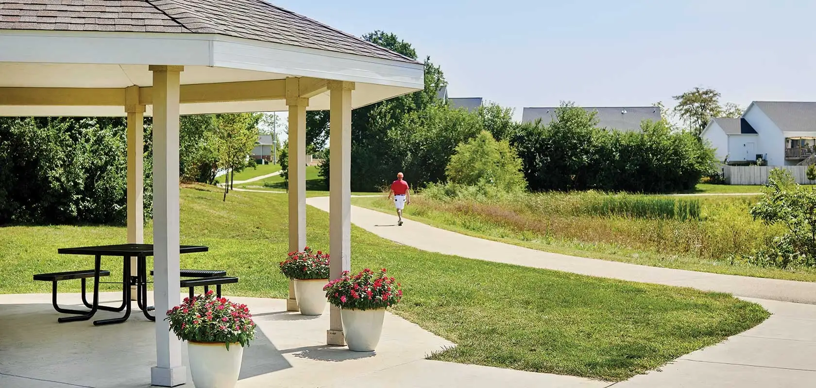 Scenic outdoor path near a gazebo with a walking resident
