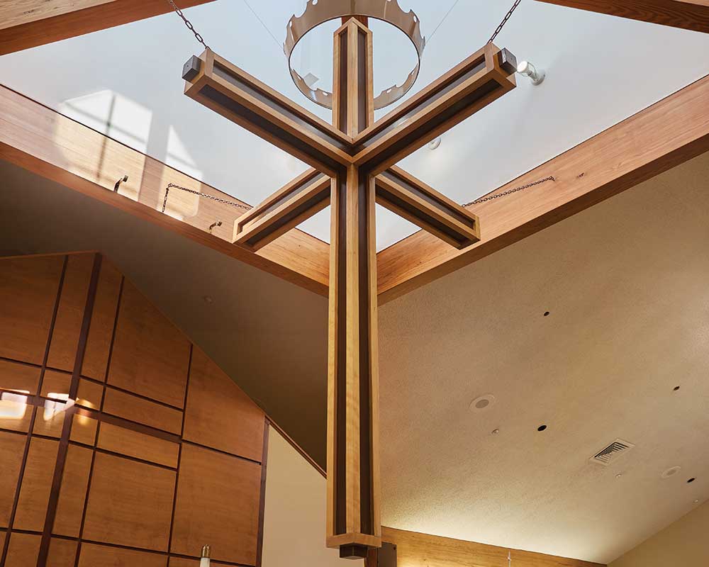 Interior view of a wooden cross hanging in a common area
