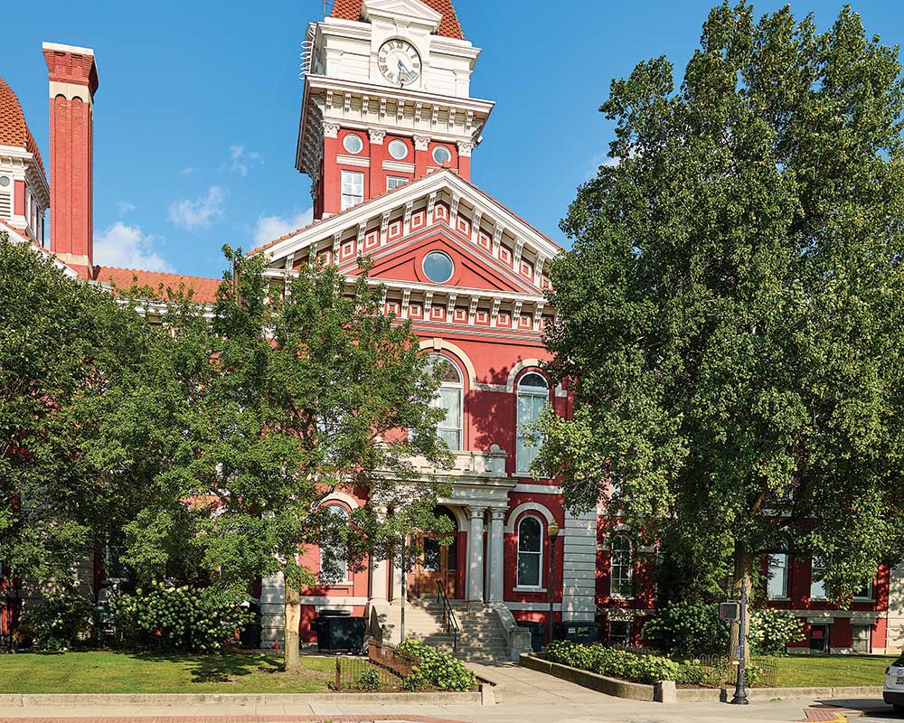 Exterior view of a historic building with greenery