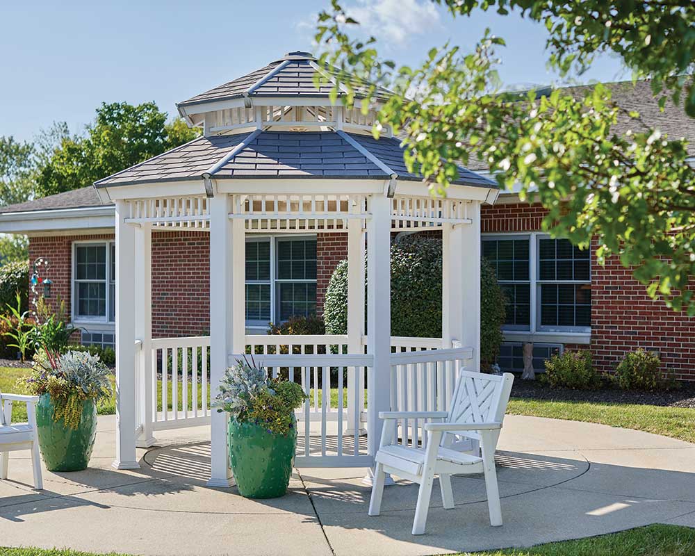 Outdoor gazebo with seating and flower pots