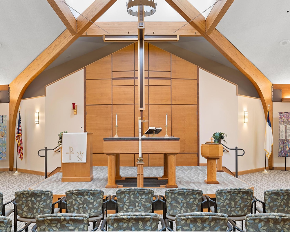 Interior view of a chapel with wooden beams and seating