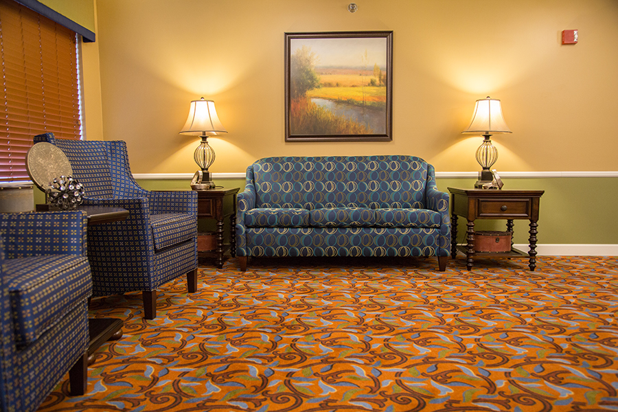 Cozy interior seating area with lamps and artwork