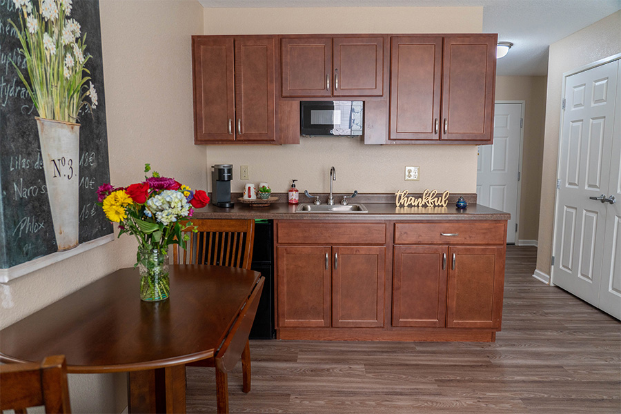 Interior view of a resident's kitchen area with flowers