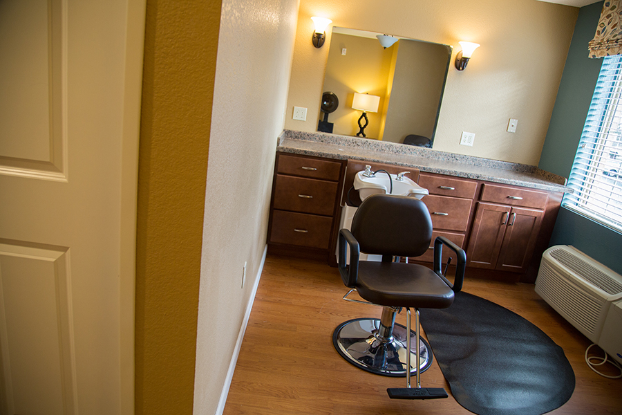 Hair salon area with styling chair and mirror