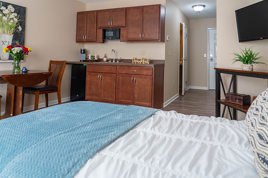 Cozy interior of a resident room with a kitchenette