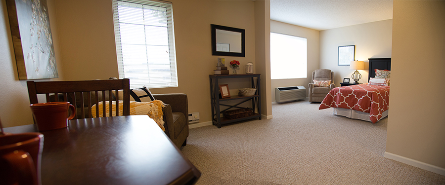 Private resident room with bed and seating area