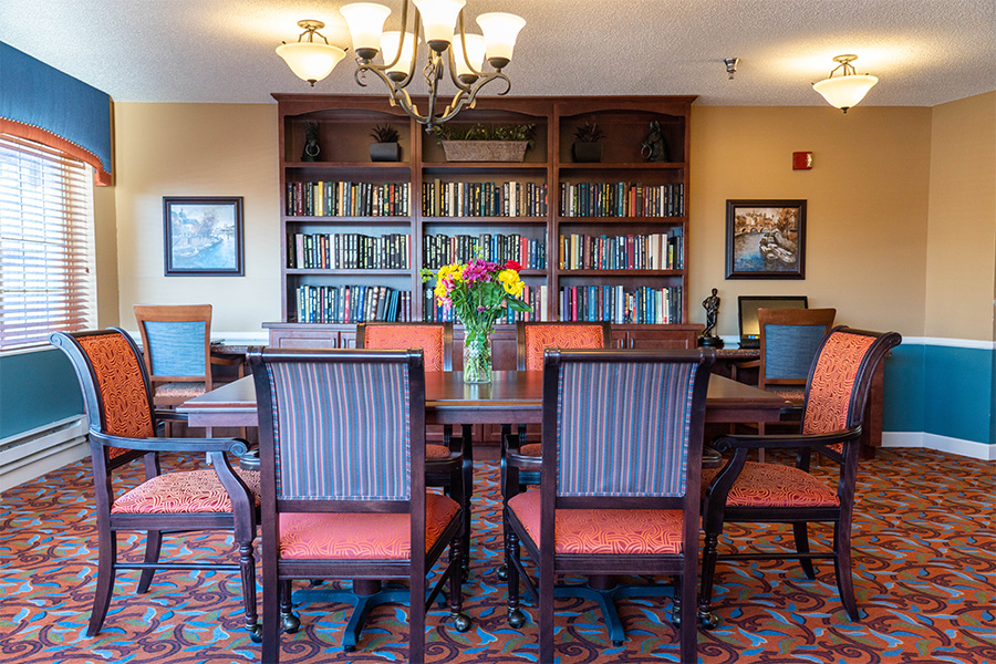 Common area with a dining table and bookshelves