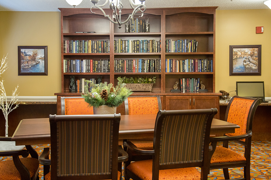 Cozy common area with bookshelves and dining table