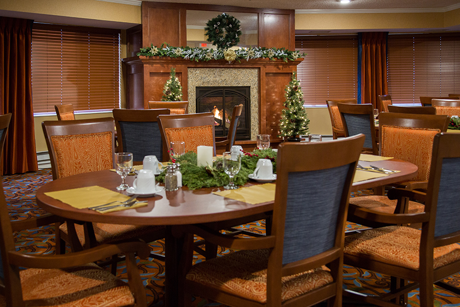 Dining room with decorated tables and a fireplace