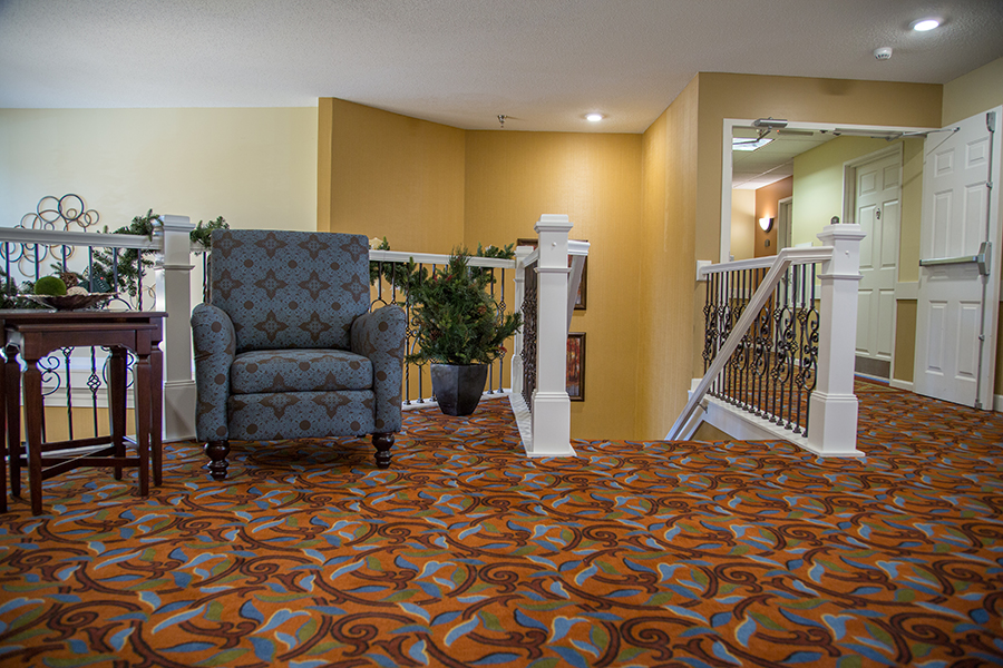 Interior view of a common area with a chair and staircase