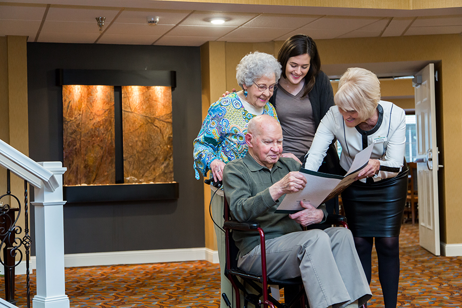 Residents and staff engaging in conversation in a welcoming common area
