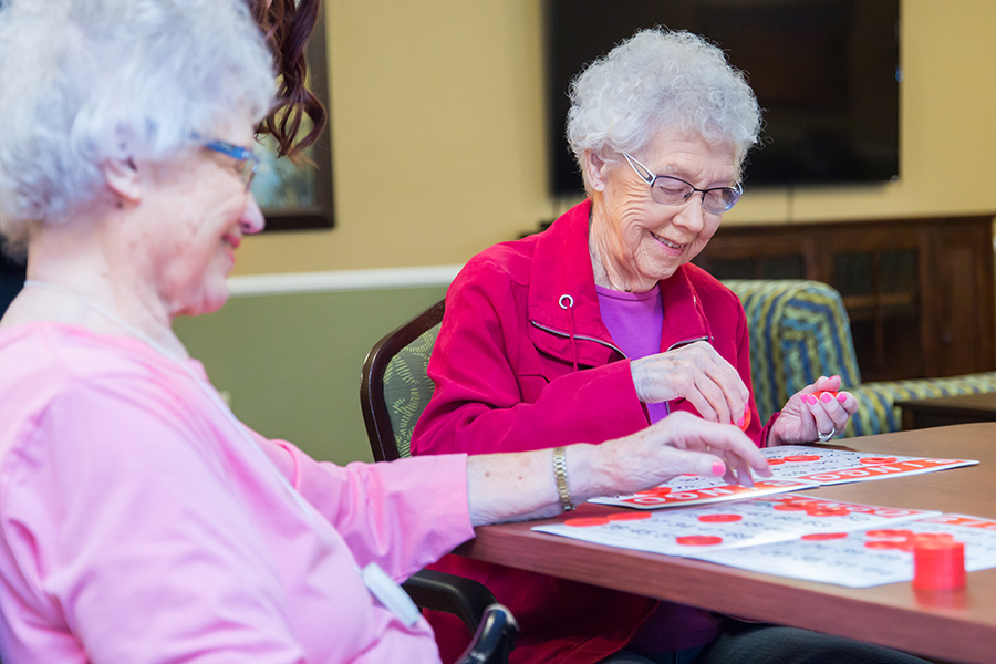 Residents engaged in a bingo game in a common area