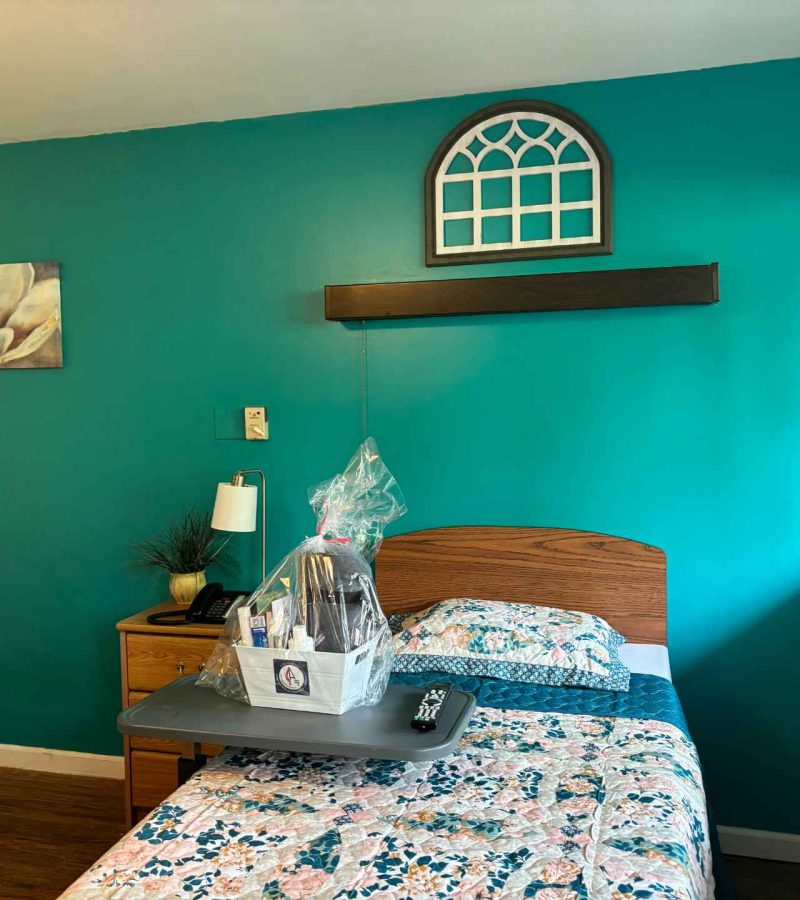Cozy resident room with teal walls and bedding