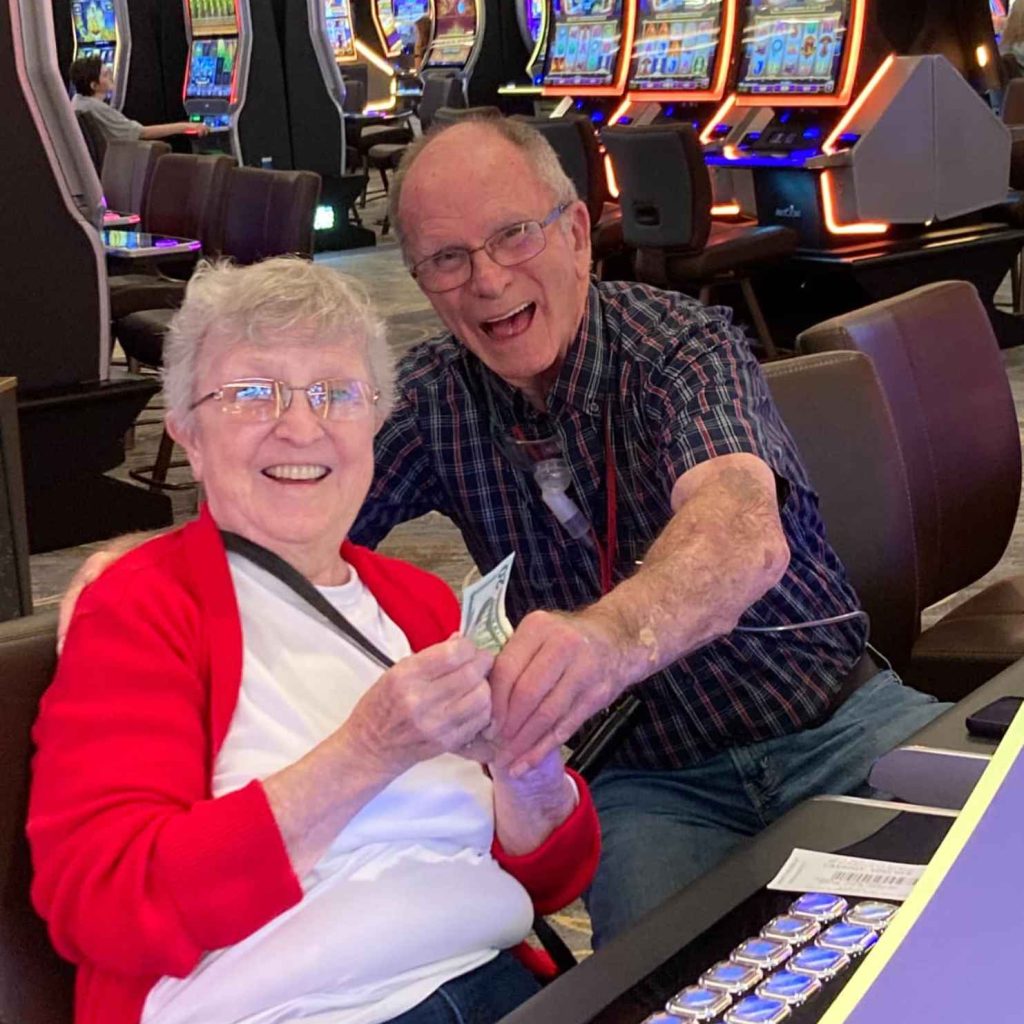 Two seniors enjoying time at a casino.