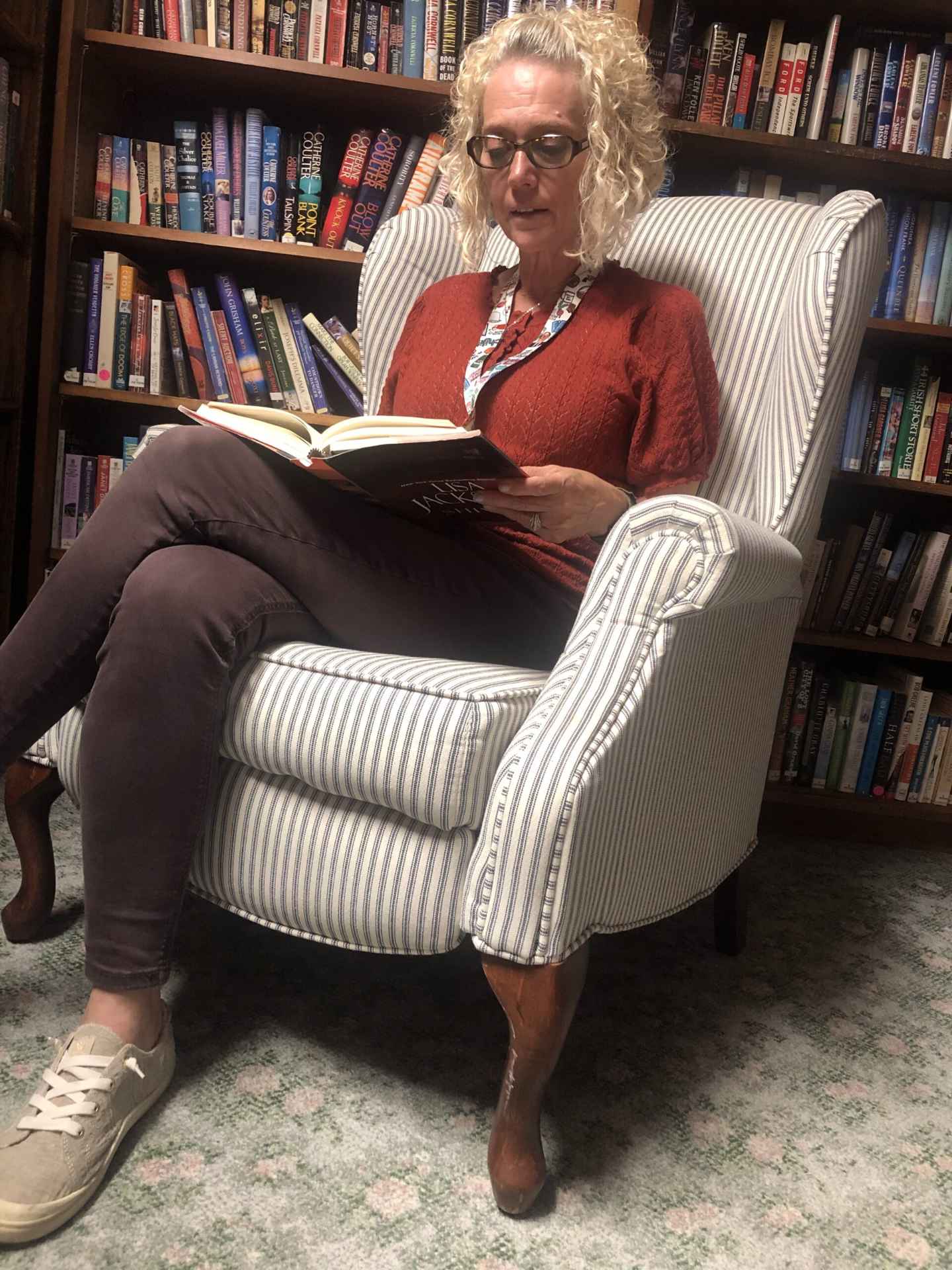 Woman reading a book in a cozy chair
