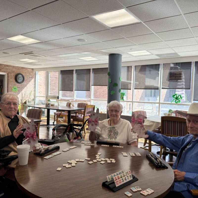 Residents engaged in a game activity in the common area.
