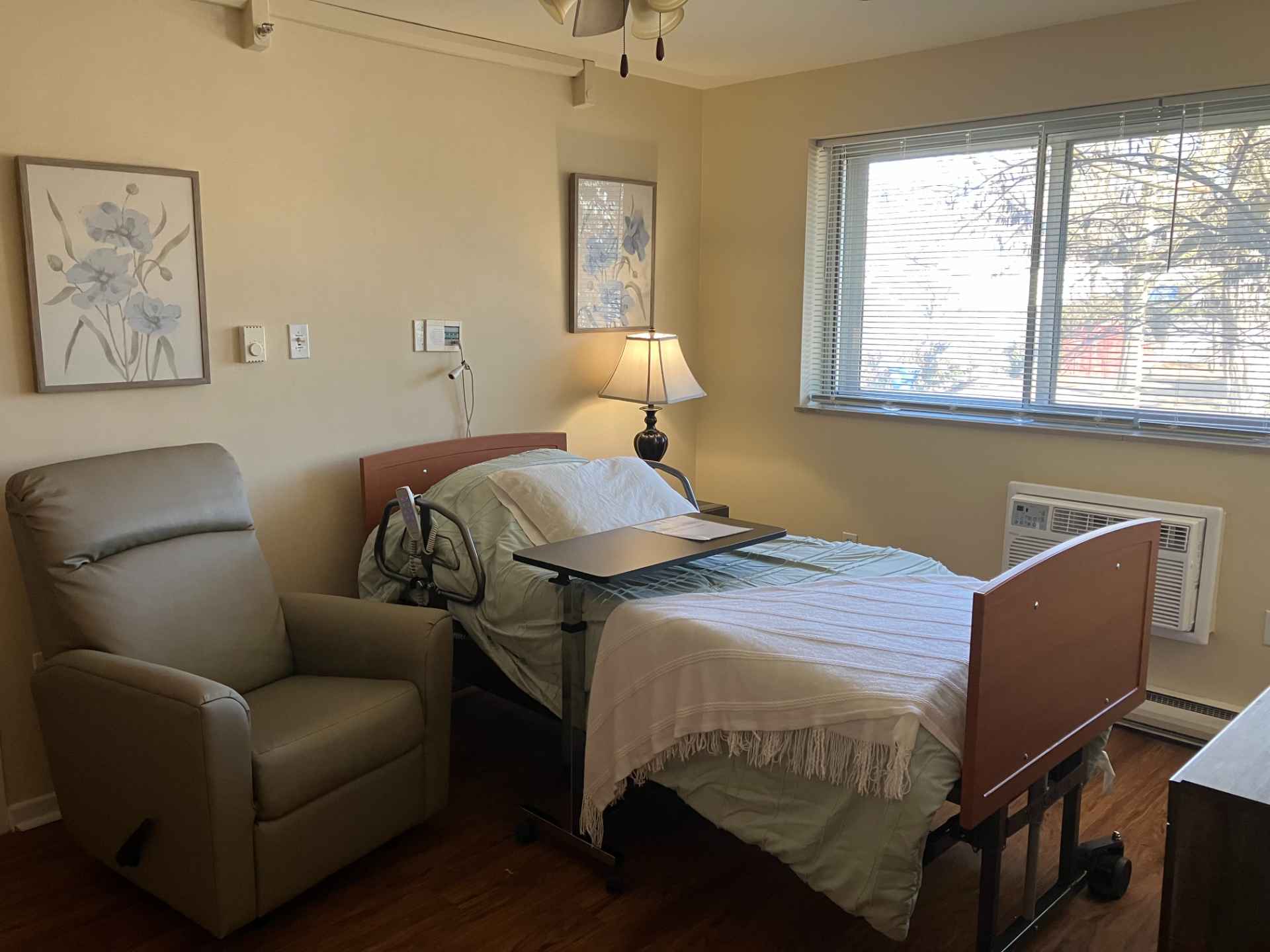 Resident room with a bed and chair.