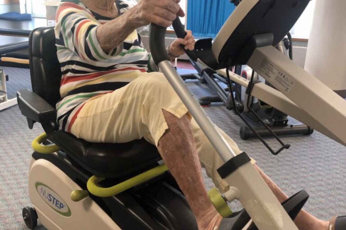 Senior using exercise equipment in a fitness area