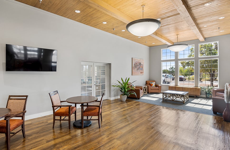 Bright common area with seating and large windows