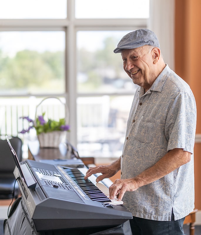 Resident playing keyboard in a common area