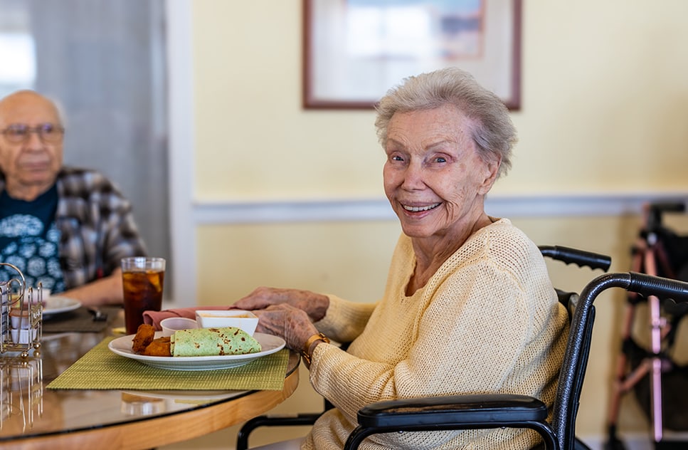 Senior resident enjoying a meal in the dining area