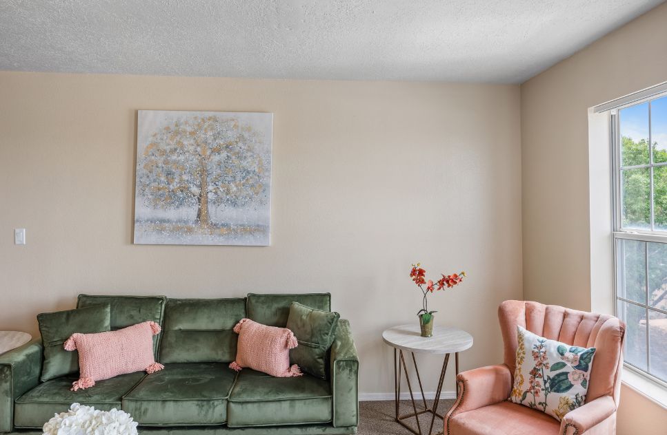 Cozy common area with green sofa and artwork