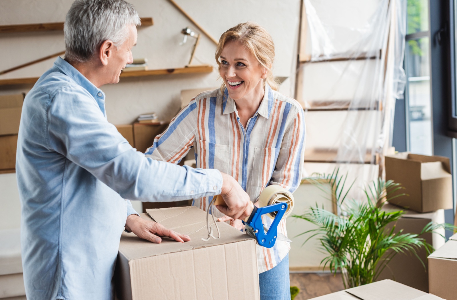 Two residents unpacking boxes in a bright indoor space