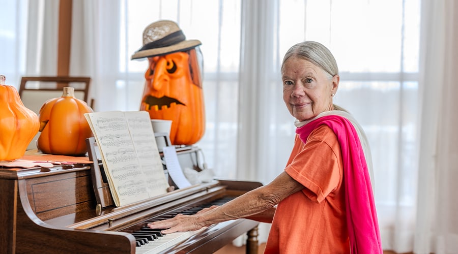 Resident playing piano with decorations