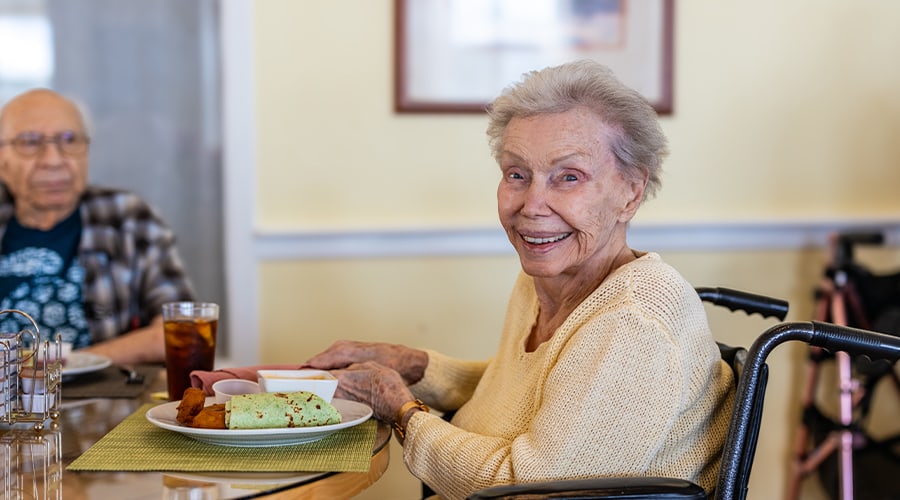 Resident enjoying a meal in the dining room
