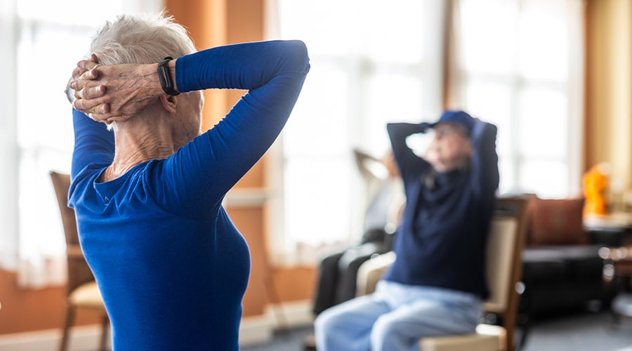 Residents engaged in a seated exercise class