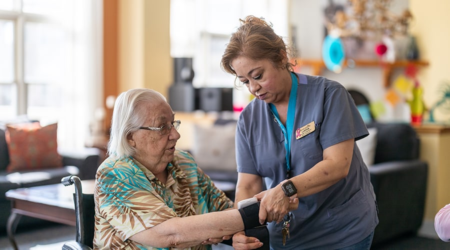 Caregiver assisting a resident in a lounge area