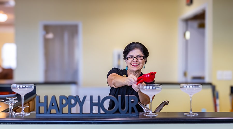 Staff member serving drinks during happy hour