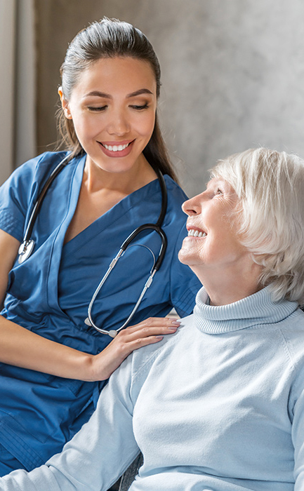 Caregiver and senior resident sharing a smile