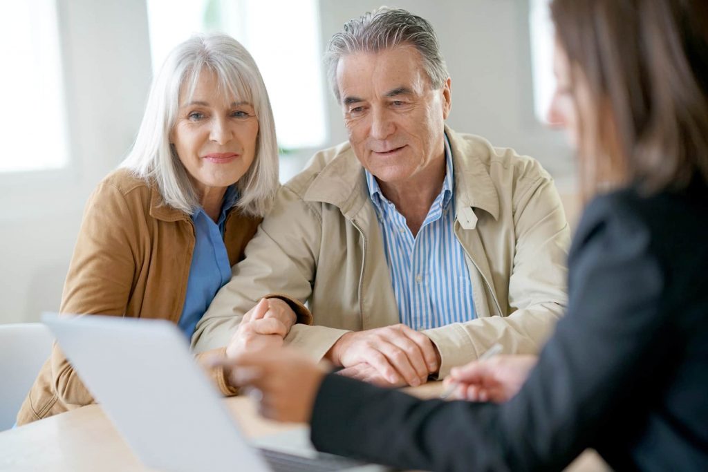 Seniors discussing with staff at a table