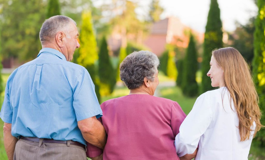 Three people enjoying a sunny outdoor space