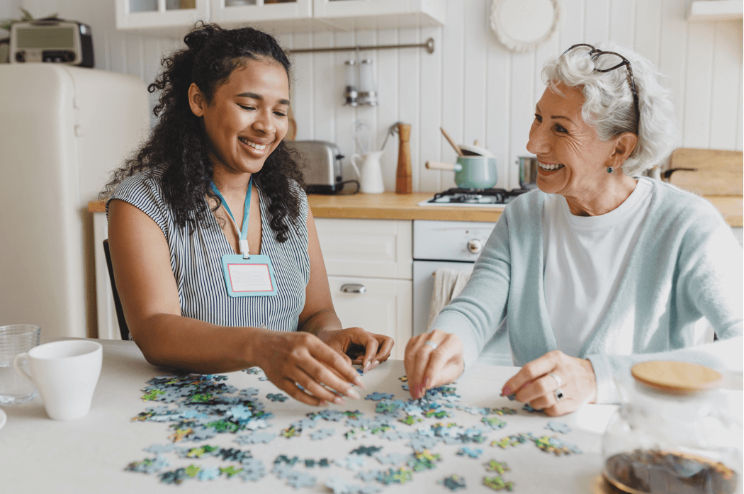 Two women enjoying a puzzle together.