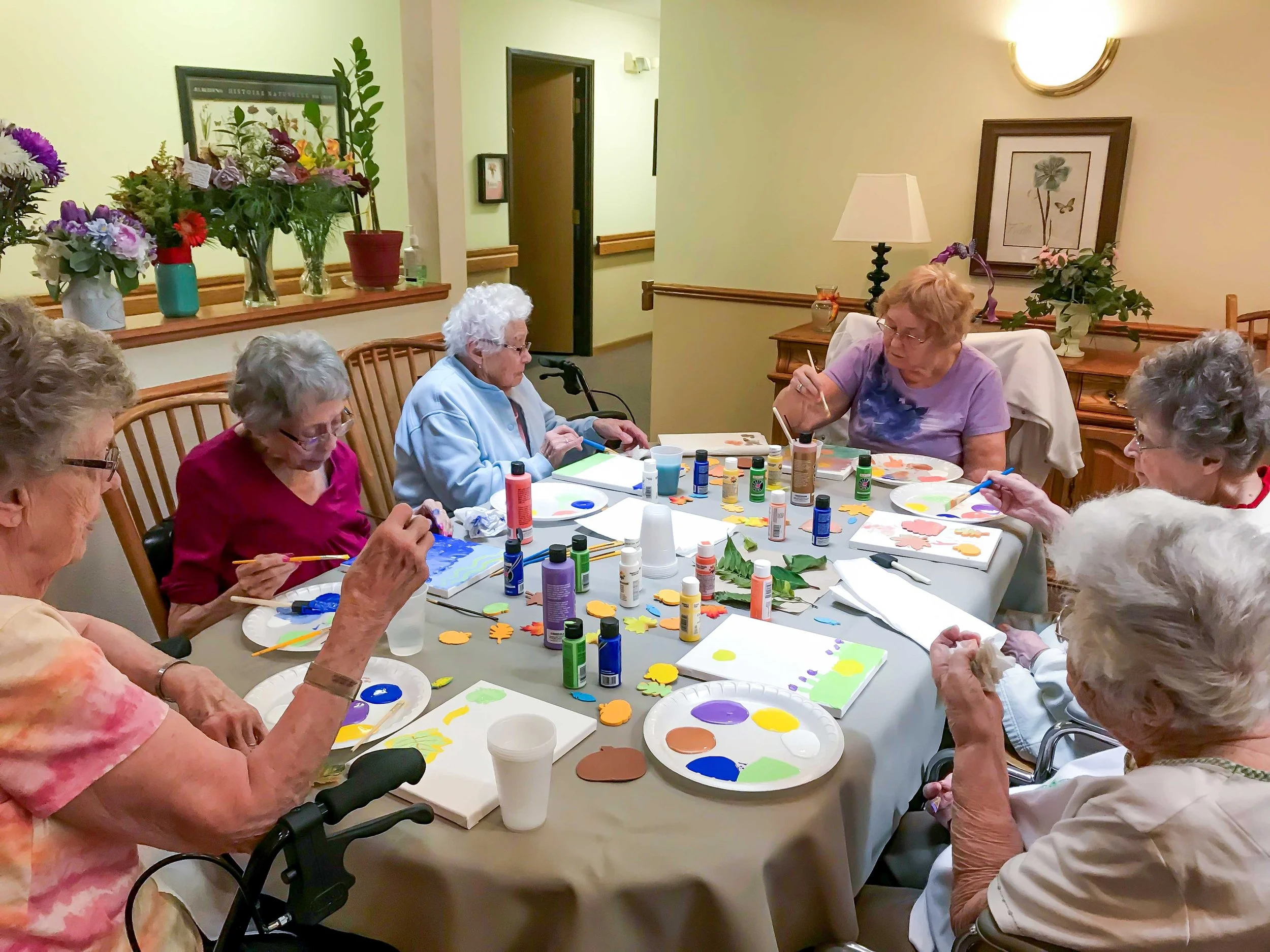 Residents engaged in a painting activity.