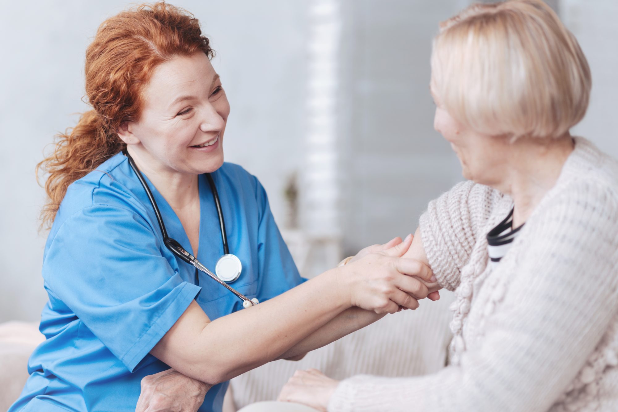 Nurse interacting warmly with elderly resident.
